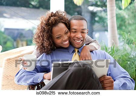 Stock Photography - Young couple with laptop. Fotosearch