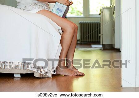 Legs of woman on bed with tissue box View Large Photo Image Stock Image - Legs of woman on bed with tissue box. Fotosearch