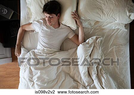Man sleeping alone in double bed View Large Photo Image Stock Image - Man sleeping alone in double bed. Fotosearch