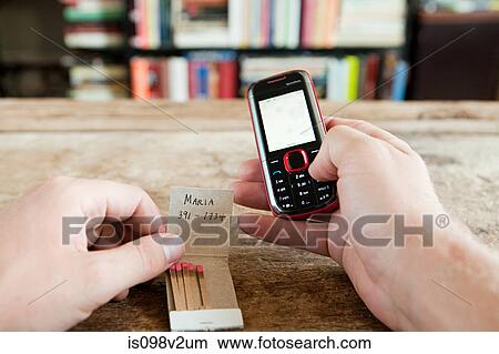 Person calling number written on matchbook View Large Photo Image Picture - Person calling number written on matchbook. Fotosearch
