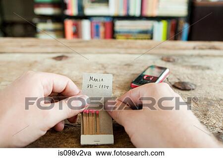 Person holding matchbook with phone number written on it View Large Photo Image Stock Image - Person holding matchbook with phone number written on it. Fotosearch