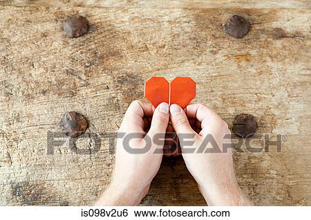 Person holding origami heart View Large Photo Image Stock Photograph - Person holding origami heart. Fotosearch
