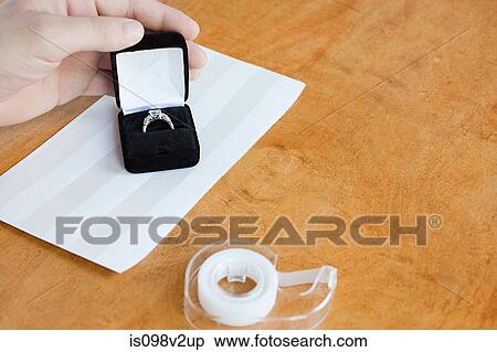 Person wrapping engagement ring View Large Photo Image Stock Photography - Person wrapping engagement ring. Fotosearch