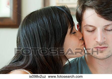 Woman kissing boyfriend on cheek View Large Photo Image Stock Photo - Woman kissing boyfriend on cheek. Fotosearch