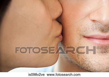Woman kissing man on cheek View Large Photo Image Stock Image - Woman kissing man on cheek. Fotosearch