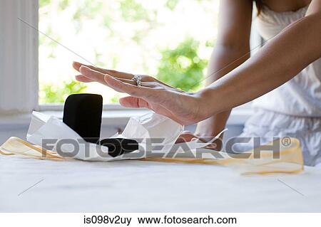 Stock Photo - Woman receiving engagement ring. Fotosearch