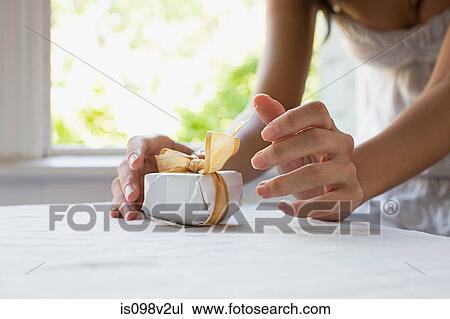 Woman with small gift View Large Photo Image Stock Image - Woman with small gift. Fotosearch