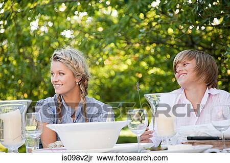Stock Photography - Brother and sister at outdoor table. Fotosearch