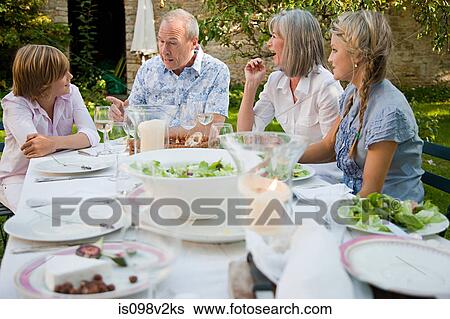 Family eating lunch outdoors View Large Photo Image Stock Photograph - Family eating lunch outdoors. Fotosearch