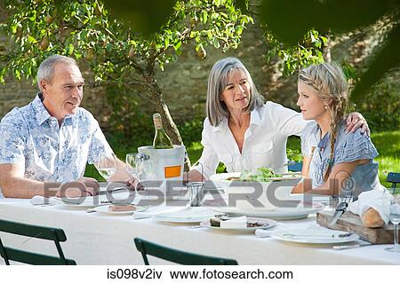Stock Photo - Family outdoors, mother with arm around daughter. Fotosearch