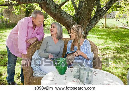Picture - Family sitting at table. Fotosearch