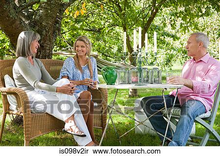 Stock Photography - Family sitting at table. Fotosearch
