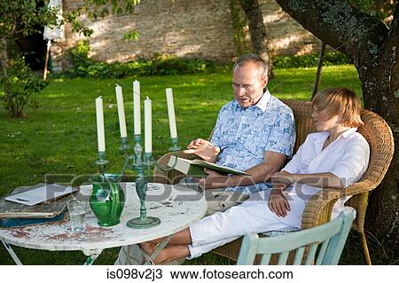Stock Image - Father and son reading book. Fotosearch