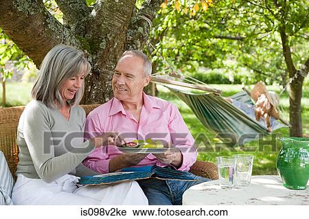 Mature couple eating from plate of food View Large Photo Image Stock Image - Mature couple eating from plate of food. Fotosearch