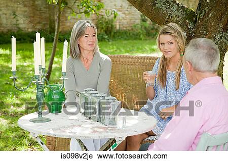 Mature couple with their daughter in garden View Large Photo Image Stock Image - Mature couple with their daughter in garden. Fotosearch