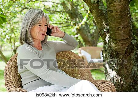 Mature woman using mobile phone View Large Photo Image Stock Image - Mature woman using mobile phone. Fotosearch