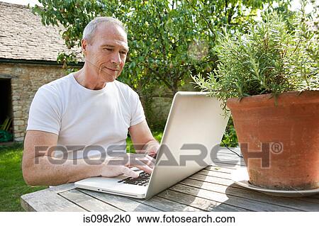 Senior man using laptop View Large Photo Image Stock Image - Senior man using laptop. Fotosearch