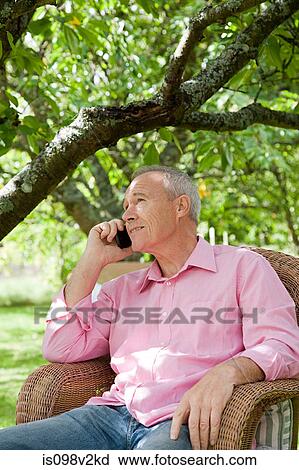 Stock Image - Senior man using mobile phone. Fotosearch