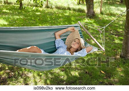 Picture - Young woman relaxing in hammock. Fotosearch