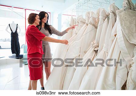 Mother and daughter looking at wedding dresses View Large Photo Image Stock Photography - Mother and daughter looking at wedding dresses. Fotosearch