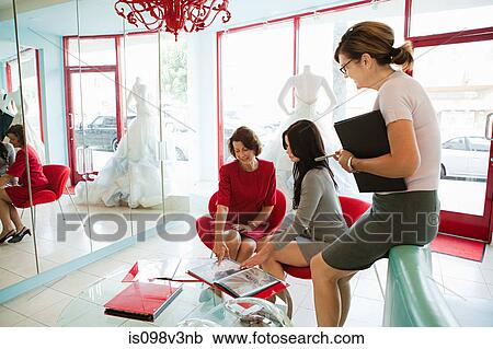 Mother and daughter talking to wedding dress designer View Large Photo Image Stock Image - Mother and daughter talking to wedding dress designer. Fotosearch