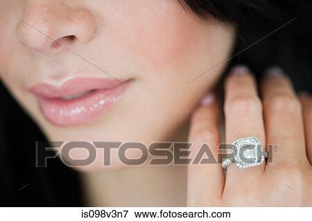 Stock Photo - Young woman wearing engagement ring. Fotosearch