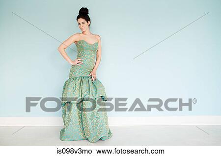 Picture - Young woman wearing green wedding dress, studio shot. Fotosearch