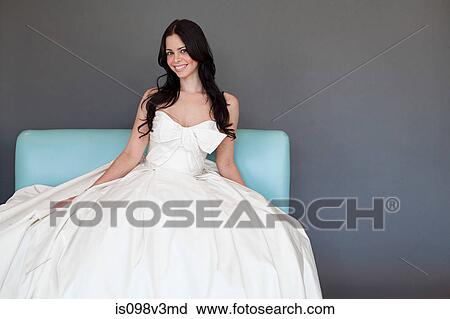 Young woman wearing white wedding dress, studio shot View Large Photo Image Stock Image - Young woman wearing white wedding dress, studio shot. Fotosearch