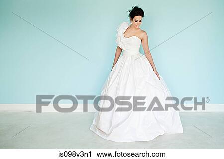 Young woman wearing white wedding dress, studio shot View Large Photo Image Stock Image - Young woman wearing white wedding dress, studio shot. Fotosearch