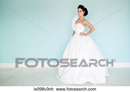 Young woman wearing white wedding dress, studio shot View Large Photo Image Stock Image - Young woman wearing white wedding dress, studio shot. Fotosearch