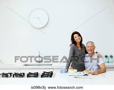 Stock Image - Mature couple having breakfast. Fotosearch