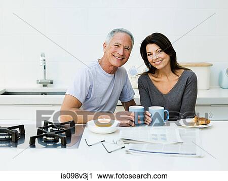 Mature couple having breakfast View Large Photo Image Stock Image - Mature couple having breakfast. Fotosearch