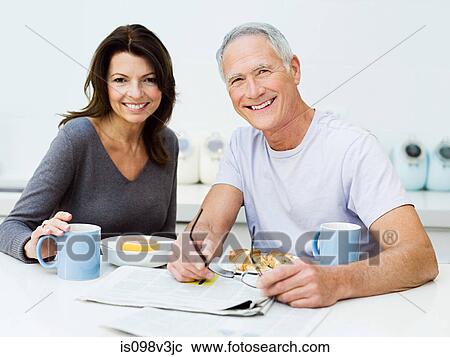 Stock Image - Mature couple having breakfast. Fotosearch