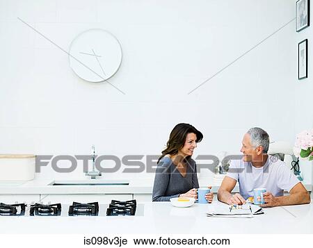 Stock Image - Mature couple having breakfast. Fotosearch