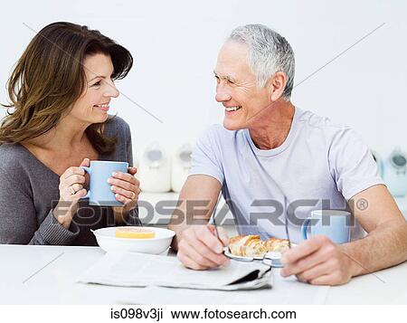 Stock Image - Mature couple having breakfast. Fotosearch