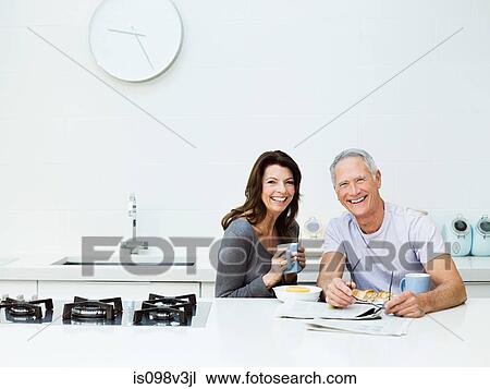Stock Image - Mature couple having breakfast. Fotosearch