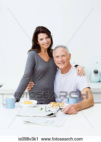 Stock Image - Mature couple having breakfast. Fotosearch