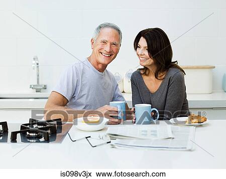 Mature couple having breakfast View Large Photo Image Stock Photo - Mature couple having breakfast. Fotosearch