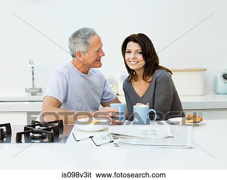 Mature couple having breakfast View Large Photo Image Stock Photograph - Mature couple having breakfast. Fotosearch