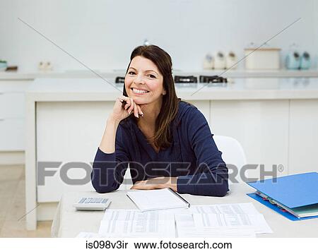 Stock Photography - Mature woman doing her finances. Fotosearch
