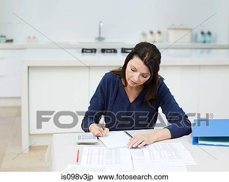 Stock Photography - Mature woman doing home finances. Fotosearch