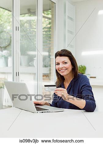 Mature woman using laptop with credit card View Large Photo Image Stock Image - Mature woman using laptop with credit card. Fotosearch