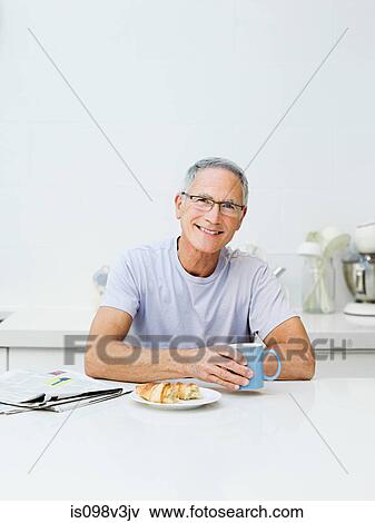 Senior man having breakfast View Large Photo Image Stock Photo - Senior man having breakfast. Fotosearch