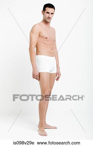 Portrait of young man wearing white boxer shorts View Large Photo Image Stock Image - Portrait of young man wearing white boxer shorts. Fotosearch