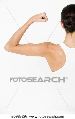 Stock Photography - Young man flexing muscles. Fotosearch