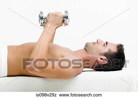 Stock Photo - Young man with hand weights. Fotosearch