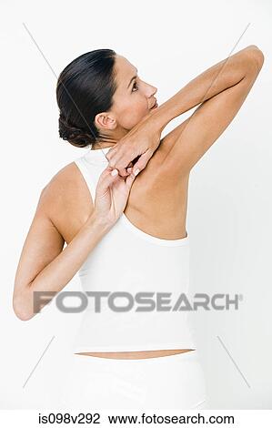 Young woman stretching View Large Photo Image Stock Image - Young woman stretching. Fotosearch