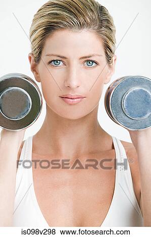 Young woman with hand weights View Large Photo Image Stock Photo - Young woman with hand weights. Fotosearch