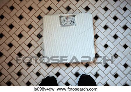 Person standing in front of bathroom scales View Large Photo Image Stock Photo - Person standing in front of bathroom scales. Fotosearch