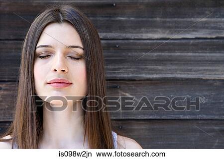 Picture - Serene woman with eyes closed. Fotosearch